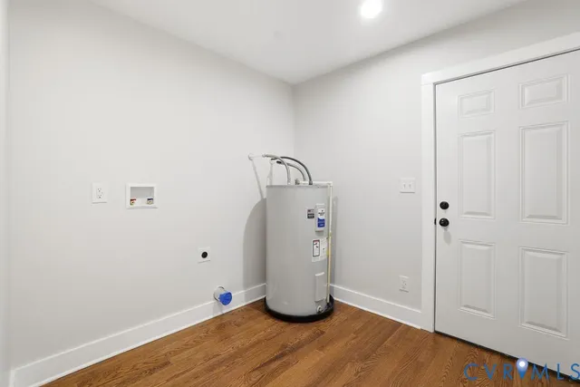 a room with wooden floor and white walls