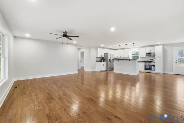 a view of a kitchen with a sink and a refrigerator