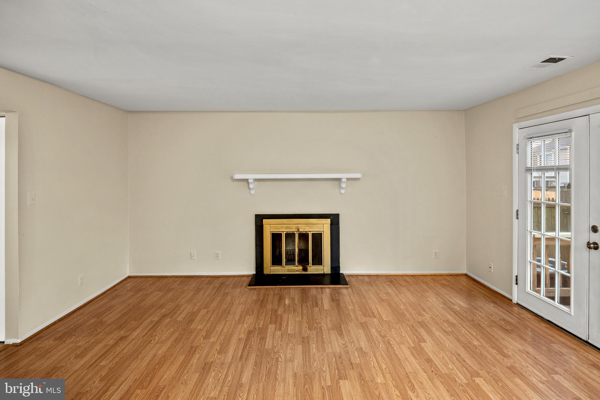 17500 Hoskinson Road Poolesville, MD 20837 - Photo 8 of 32 a view of an empty room with wooden floor and a window
