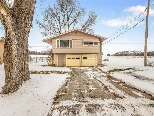 a view of a house with a yard covered in snow