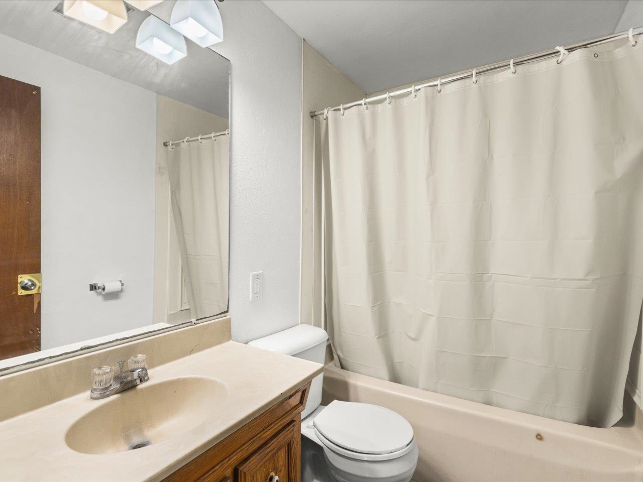 4381 Safford Road Rockford, IL 61101 - Photo 12 of 21 a bathroom with a sink a toilet and shower curtain