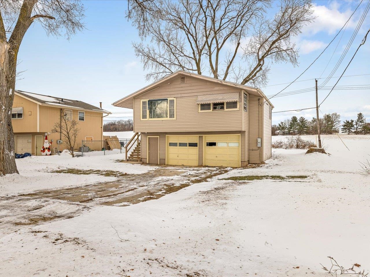 4381 Safford Road Rockford, IL 61101 - Photo 2 of 21 a front view of a house with a yard covered in snow