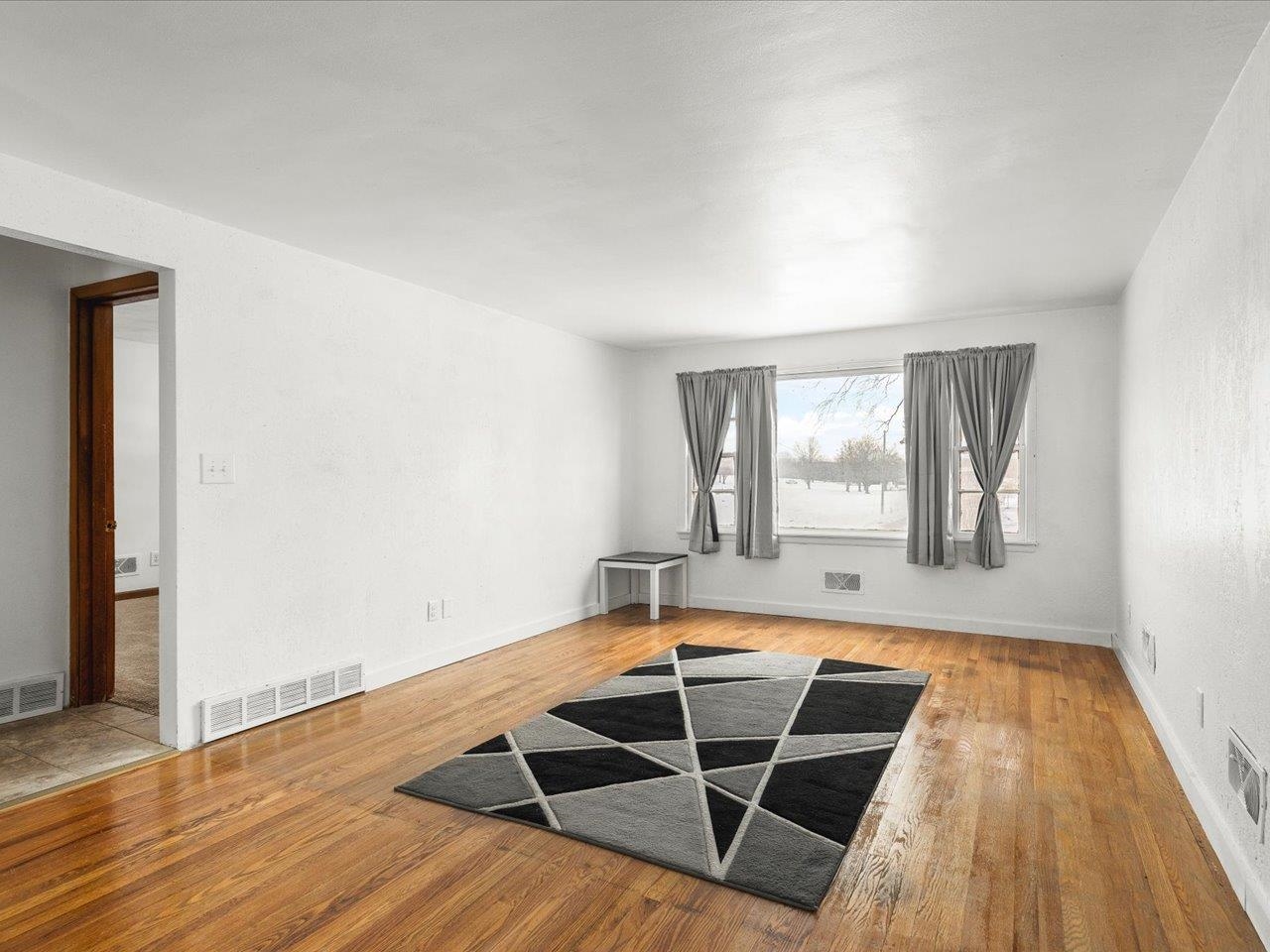4381 Safford Road Rockford, IL 61101 - Photo 4 of 21 an empty room with wooden floor and windows
