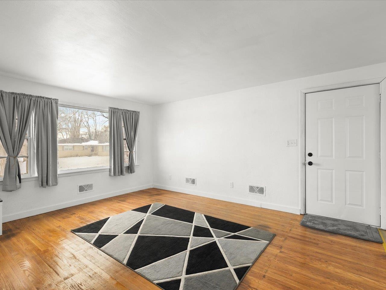 4381 Safford Road Rockford, IL 61101 - Photo 5 of 21 a view of an empty room with wooden floor and a window