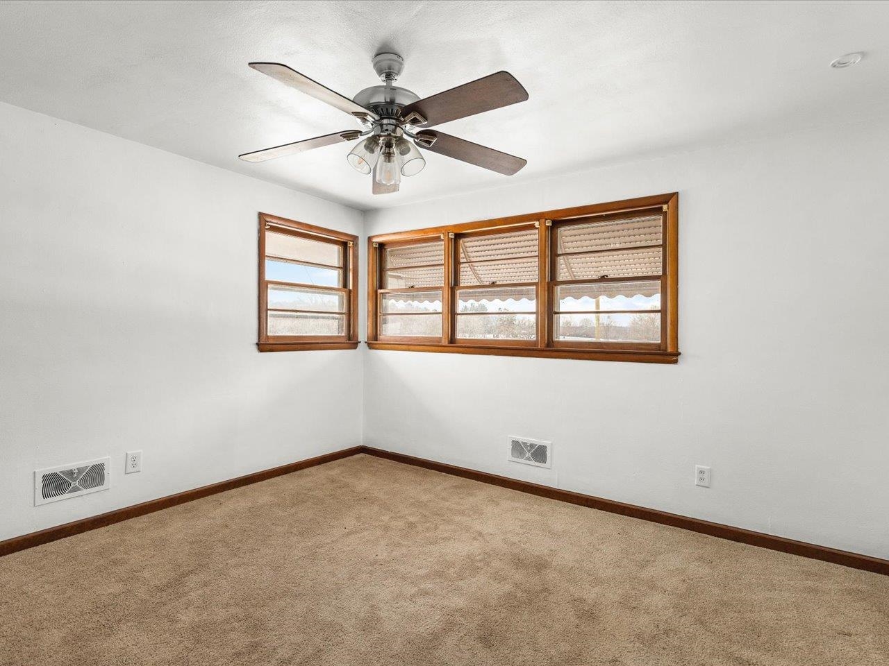 4381 Safford Road Rockford, IL 61101 - Photo 10 of 21 an empty room with windows and fan