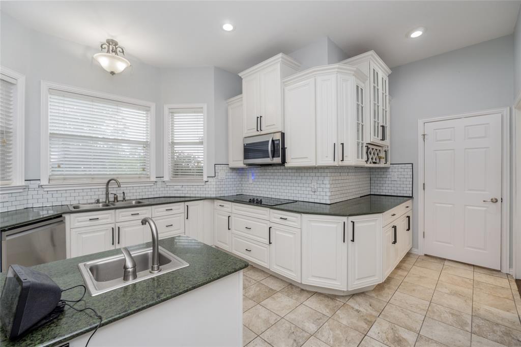 135 Kirkpatrick Road Ennis, TX 75119 - Photo 8 of 40 a kitchen with stainless steel appliances granite countertop a sink and a stove