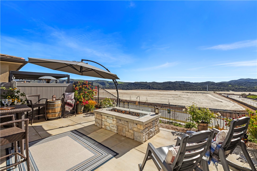 821 Cornelia Way Rancho Mission Viejo, CA 92694 - Photo 1 of 61 a view of a patio with lawn chairs under an umbrella