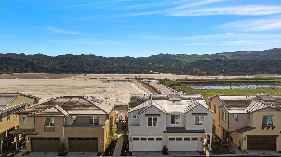 821 Cornelia Way Rancho Mission Viejo, CA 92694 - Photo 29 of 61 a view of a white house with a lake view