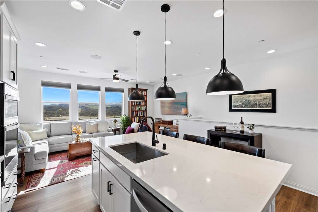 821 Cornelia Way Rancho Mission Viejo, CA 92694 - Photo 5 of 61 a kitchen with a table chairs and a view of living room