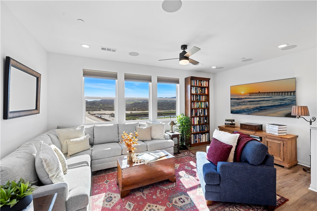 821 Cornelia Way Rancho Mission Viejo, CA 92694 - Photo 9 of 61 a living room with furniture ceiling fan and a flat screen tv