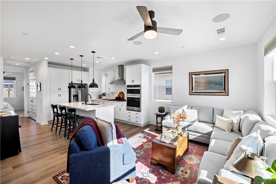 821 Cornelia Way Rancho Mission Viejo, CA 92694 - Photo 10 of 61 a living room with fireplace furniture and a wooden floor