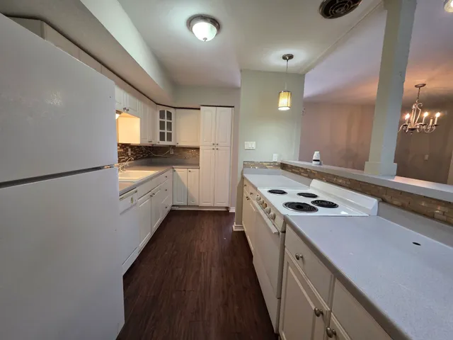 a kitchen with a stove a sink and a refrigerator