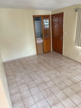 a view of an empty room and a window