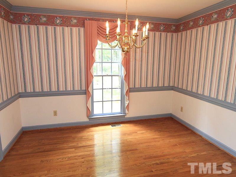103 Calms Way Rougemont, NC 27572 - Photo 4 of 13 a view of an empty room with a window and hardwood floor