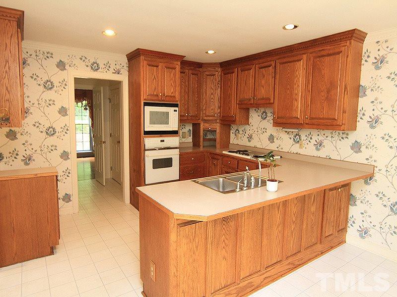 103 Calms Way Rougemont, NC 27572 - Photo 5 of 13 a kitchen with stainless steel appliances granite countertop a sink stove and refrigerator