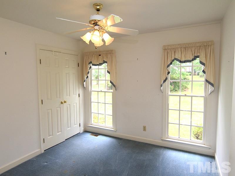 103 Calms Way Rougemont, NC 27572 - Photo 8 of 13 an empty room with windows and chandelier