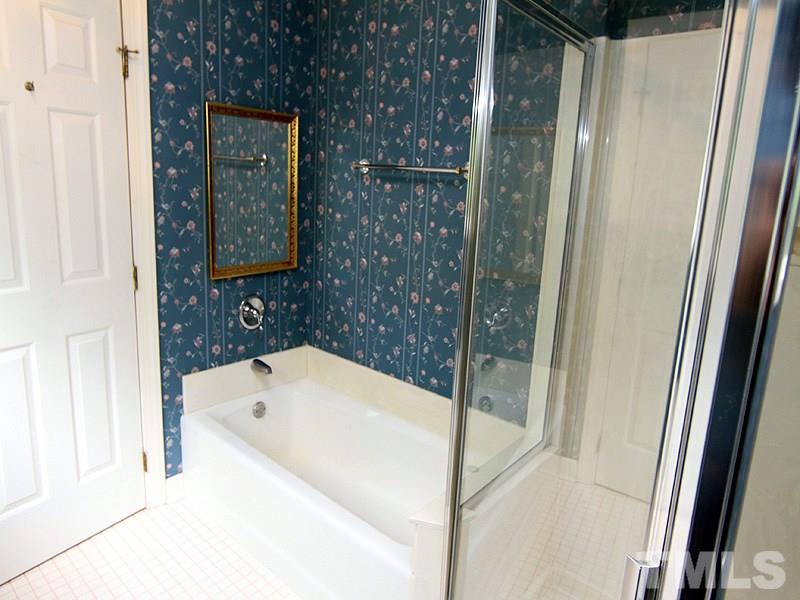 103 Calms Way Rougemont, NC 27572 - Photo 10 of 13 a bathroom with a bathtub and shower