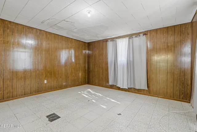 a view of an empty room with wooden walls