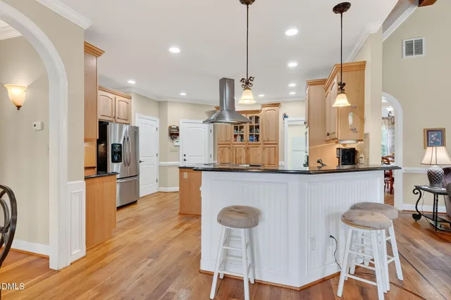 a kitchen with counter top space cabinets and refrigerator