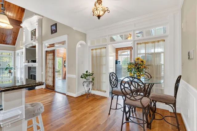 a bathroom with a tub sink double vanity and a mirror