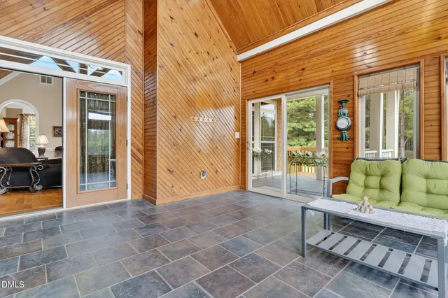 a view of an empty room with a fireplace and a window