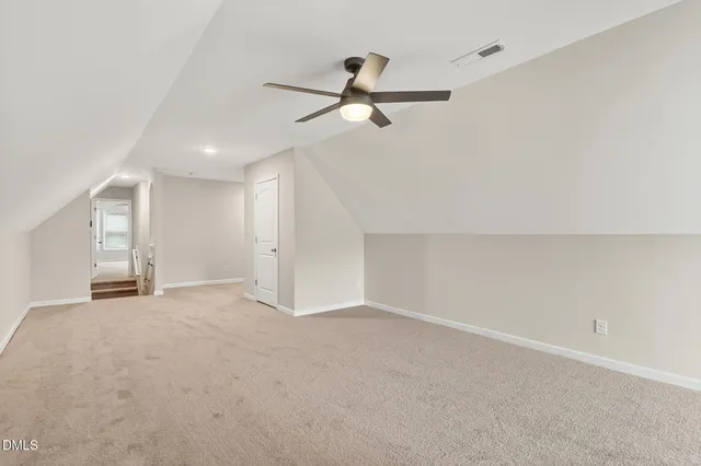 a view of a house with a ceiling fan and wooden floor