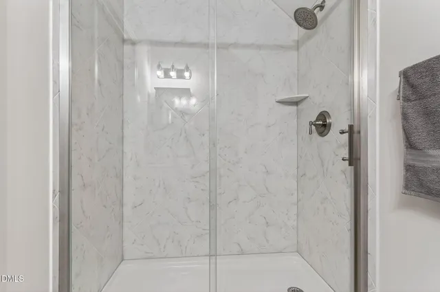 a view of an empty room with a cabinet and a window