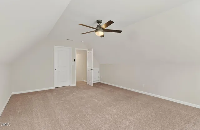 a view of an empty room with a ceiling fan