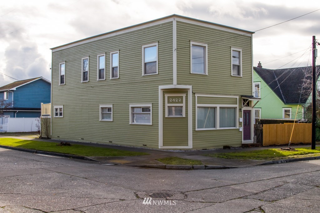 a front view of a house with a yard and a garage