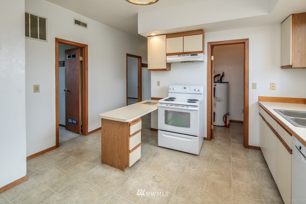 2422 E Street Bellingham, WA 98225 - Photo 5 of 15 a kitchen with stainless steel appliances granite countertop a stove and a refrigerator