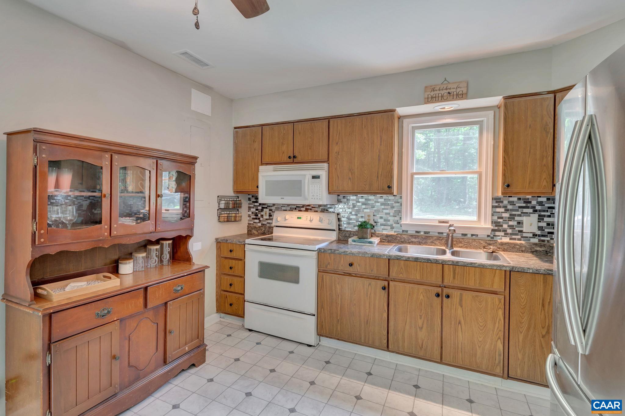 2597 Ridge Road Palmyra, VA 22963 - Photo 12 of 28 a kitchen with a stove a sink and a refrigerator