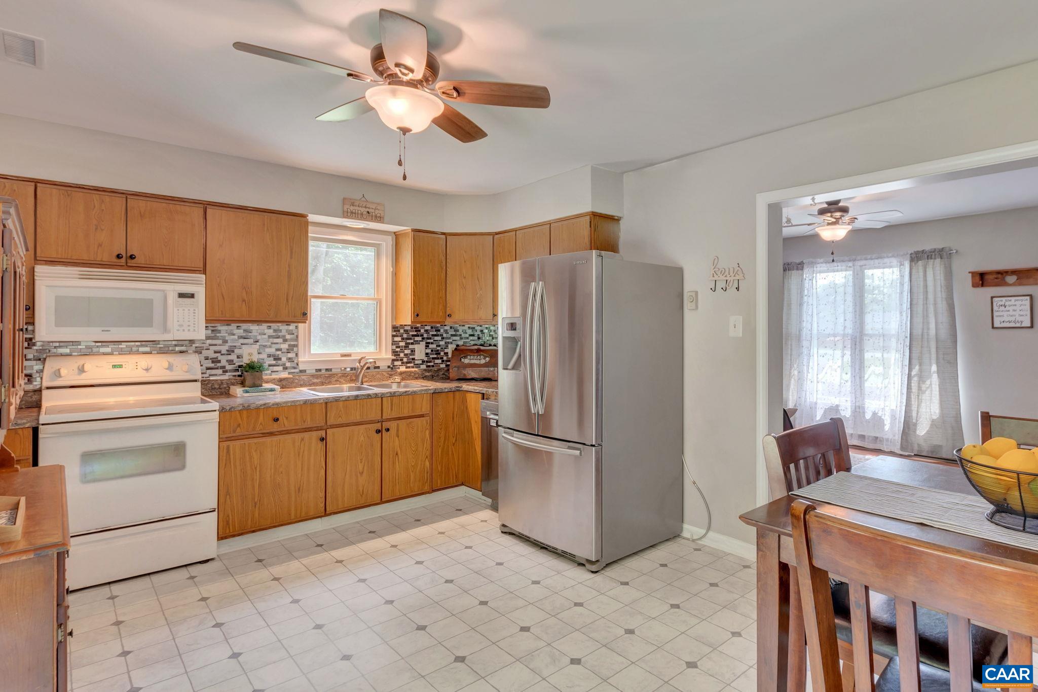 2597 Ridge Road Palmyra, VA 22963 - Photo 13 of 28 a kitchen with a refrigerator a stove a sink cabinets and a dining table