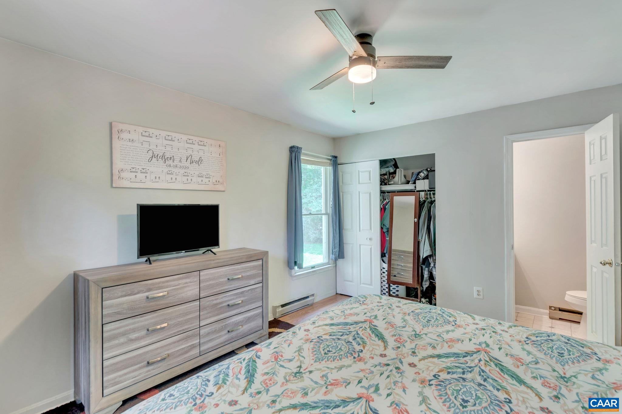 2597 Ridge Road Palmyra, VA 22963 - Photo 19 of 28 a bedroom with a bed and a flat screen tv