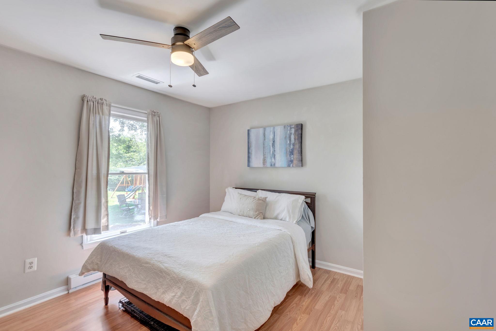 2597 Ridge Road Palmyra, VA 22963 - Photo 22 of 28 a bedroom with a bed and a chandelier