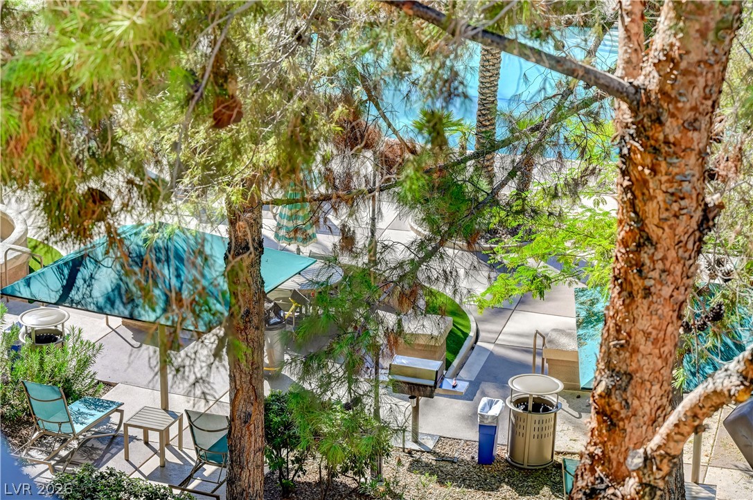 230 East Flamingo Road, Unit 333 Las Vegas, NV 89169 - Photo 40 of 61 Mature trees frame a view of the community pool and shared patio areas below.