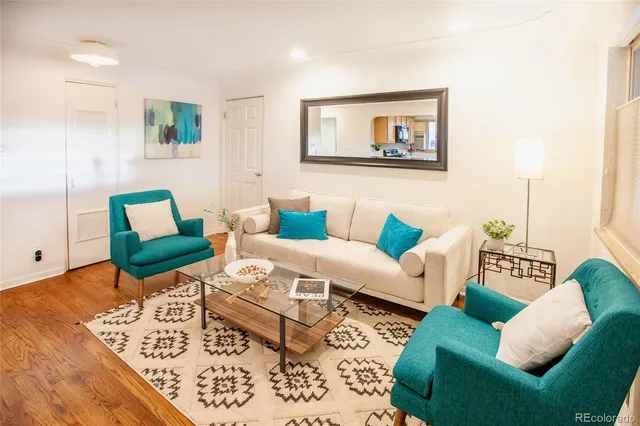 a living room with furniture and wooden floor