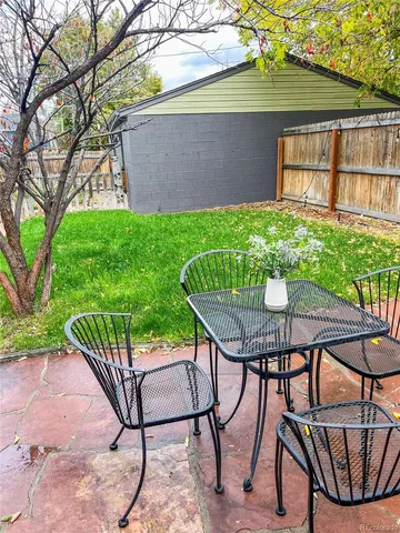 a view of a chairs and table in backyard