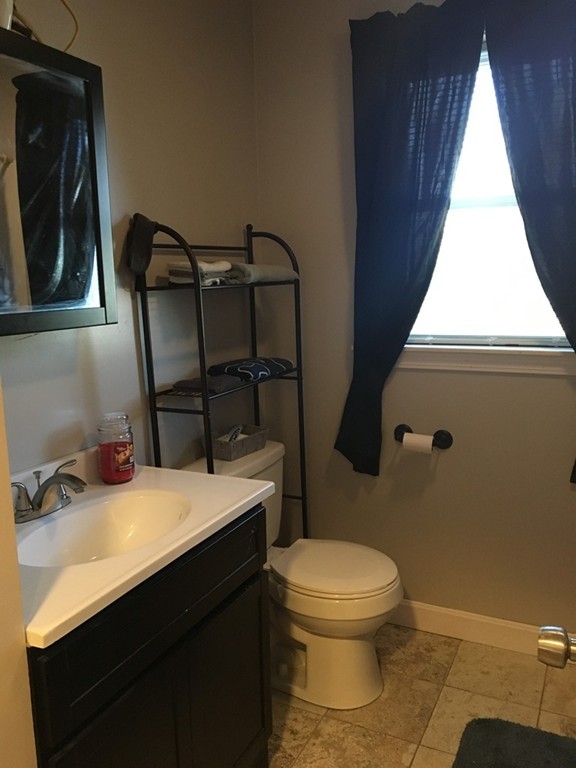 44 Lepes Road Somerset, MA 02726 - Photo 8 of 8 a bathroom with a sink a toilet and mirror