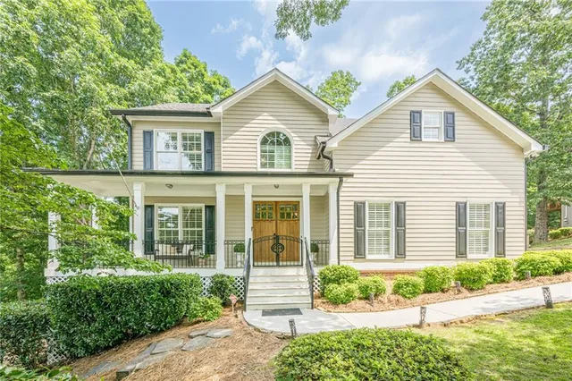 a view of a house with a yard and potted plants