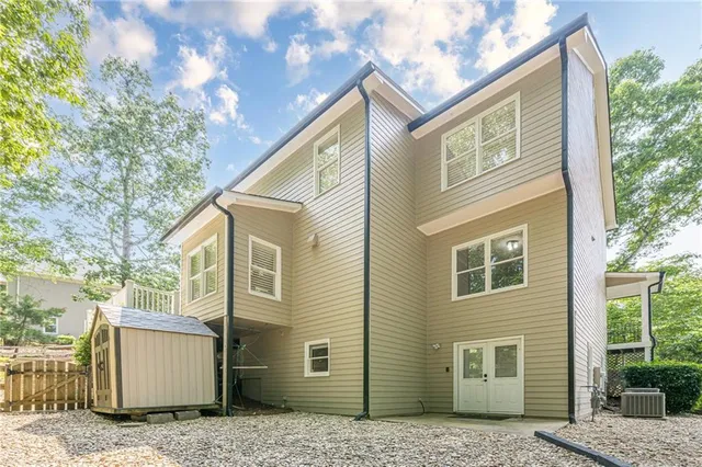a view of a hallway with wooden floor and stairs