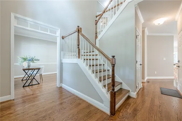 a kitchen with stainless steel appliances granite countertop a refrigerator and wooden cabinets