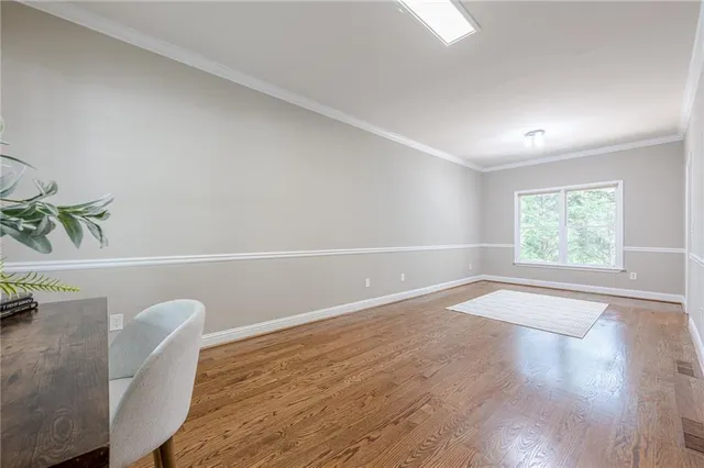 a dining room with furniture a chandelier and wooden floor
