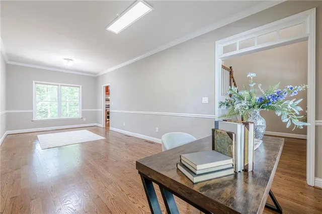 a view of a hallway with wooden floor and staircase