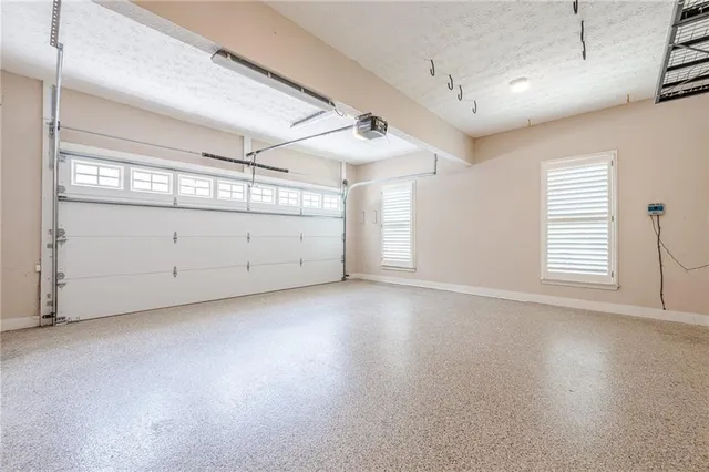 a front view of a house with a yard and potted plants