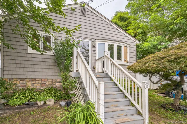 a view of a house with wooden fence and large windows