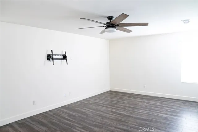 a view of a room with wooden floor