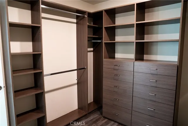 a view of walk in closet with empty racks