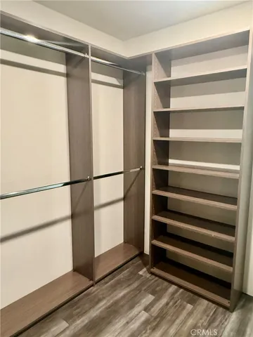 a utility room with wooden floor washer and dryer