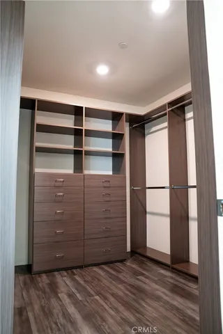 a utility room with wooden floor washer and dryer