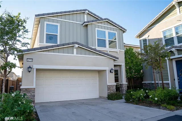 a view of a house with two chairs and a window